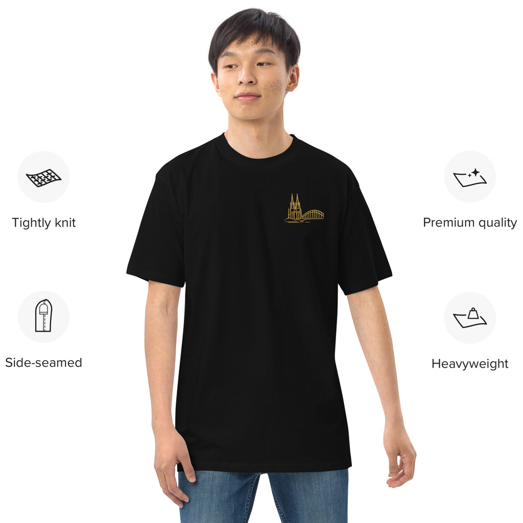 Person wearing a black t-shirt with a gold logo on a white background