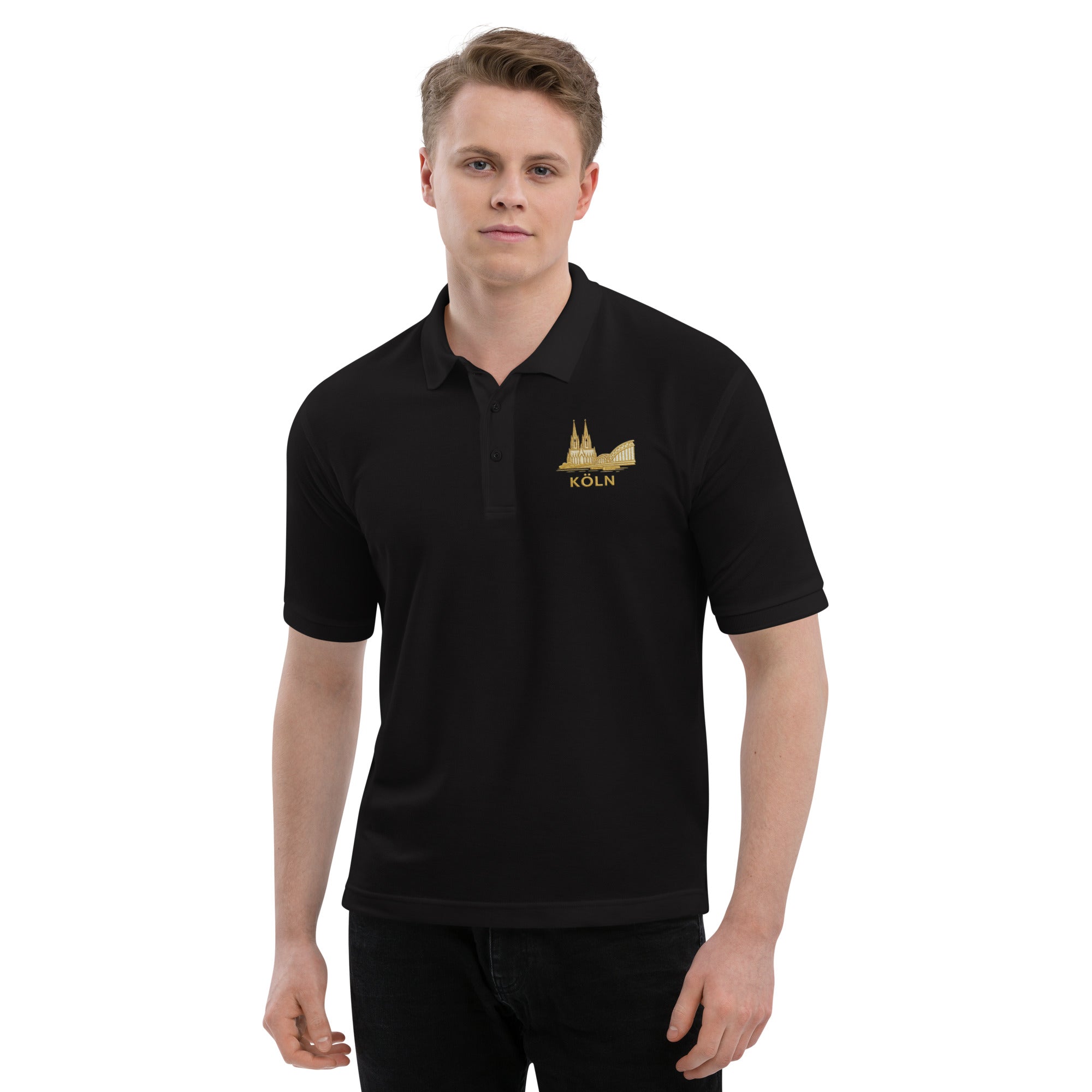 Man wearing a black polo shirt with a gold emblem on a white background