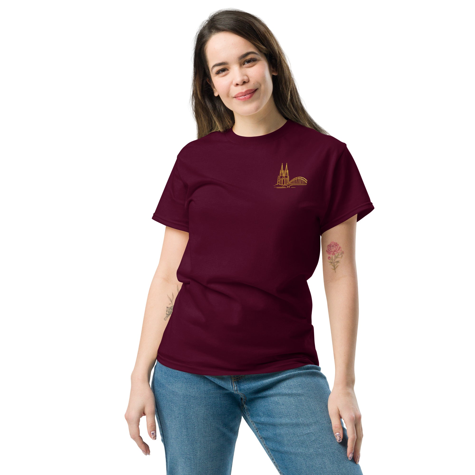 Woman wearing a maroon t-shirt with a small logo on a white background