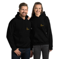 Two people wearing black Köln hoodies with a logo on a white background