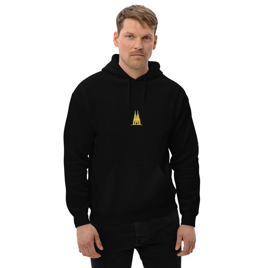 Man wearing a black hoodie with a ygold köln logo on a white background
