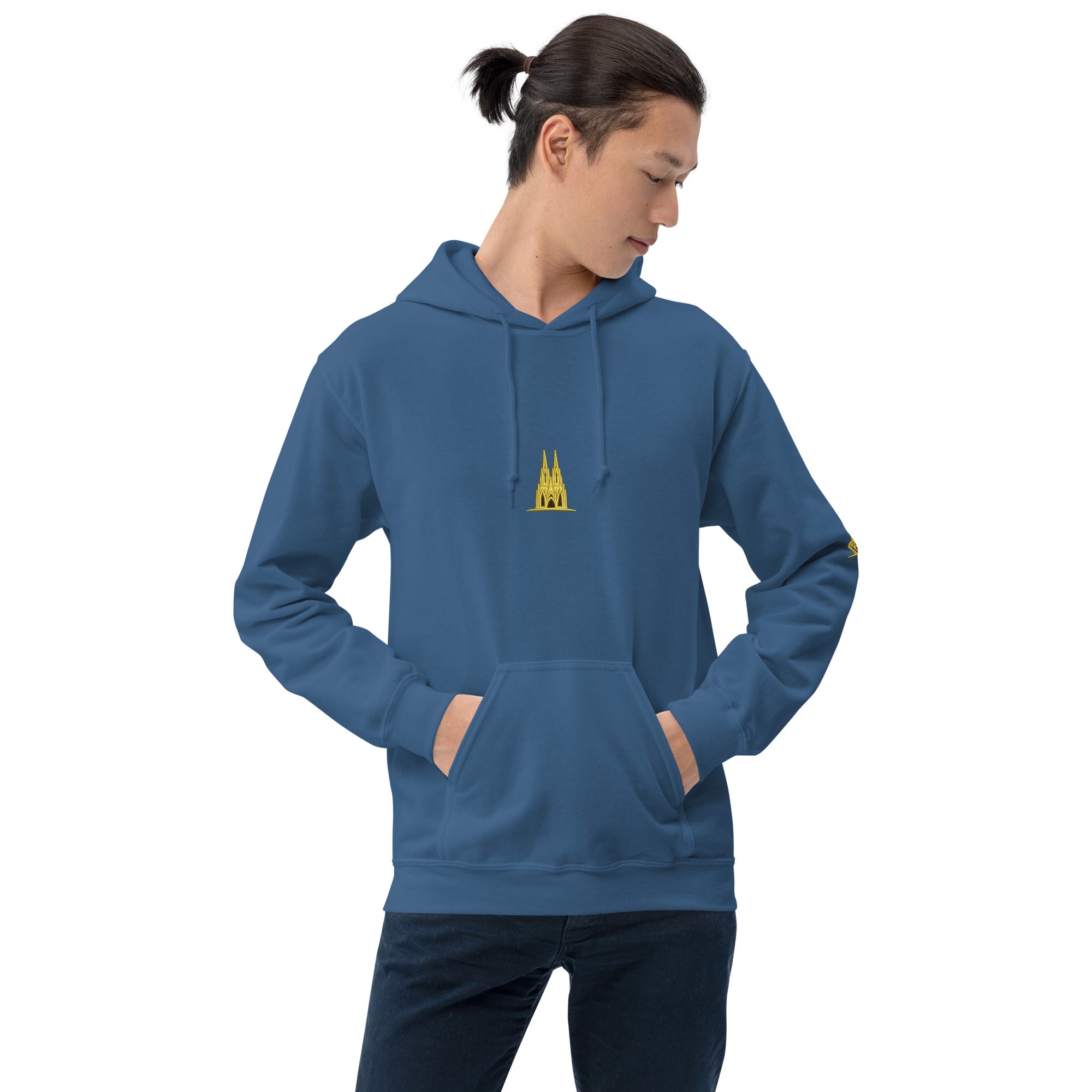 Person wearing a indigo blue hoodie with a small gold köln design on a white background