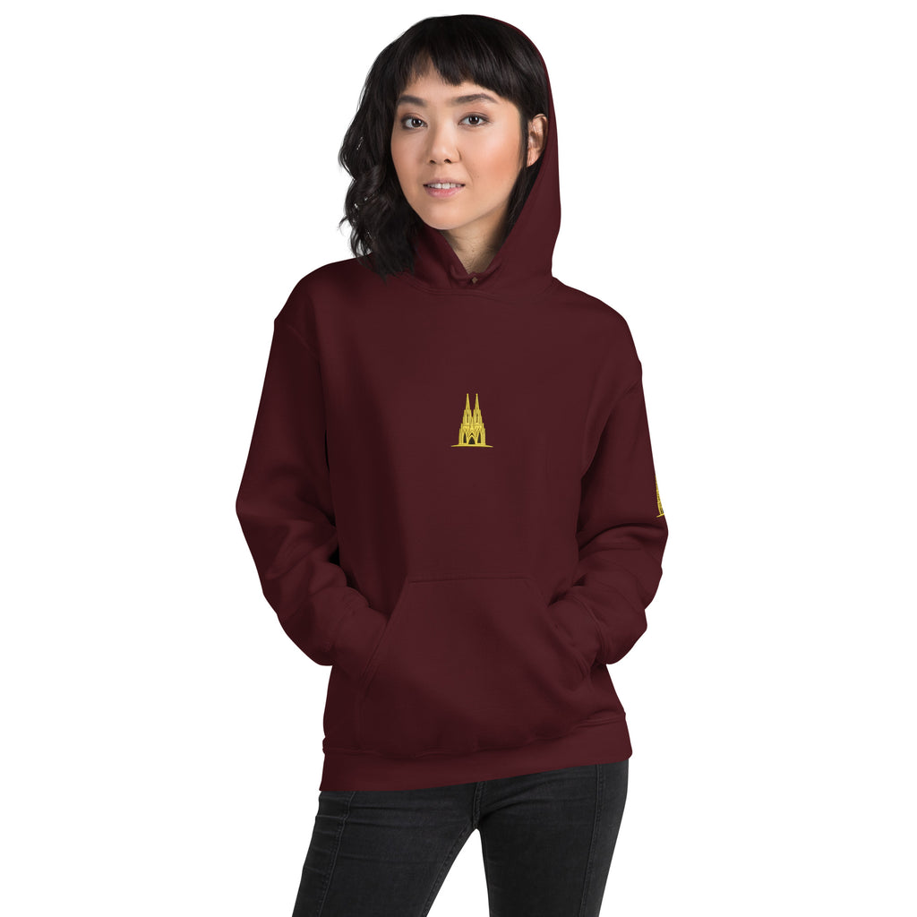 Person wearing a maroon hoodie with a Köln gold logo on a white background