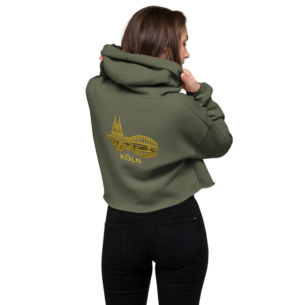 Person wearing a green hoodie with a yellow logo on the back, standing against a white background